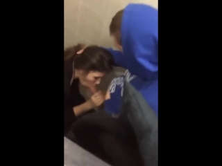 cute young brunette gets caught giving head in a public bathroom